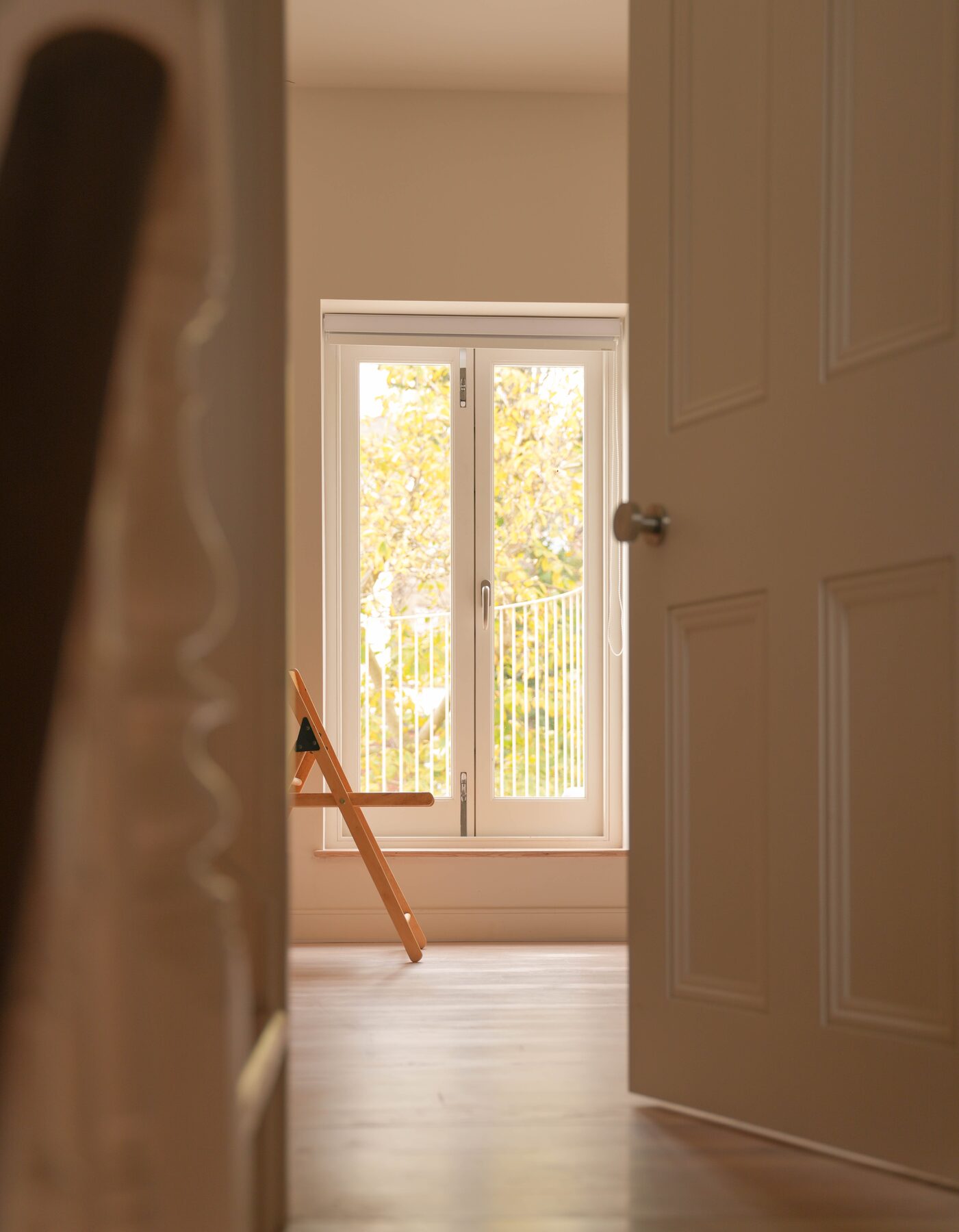 Hallway framing French doors and autumn garden