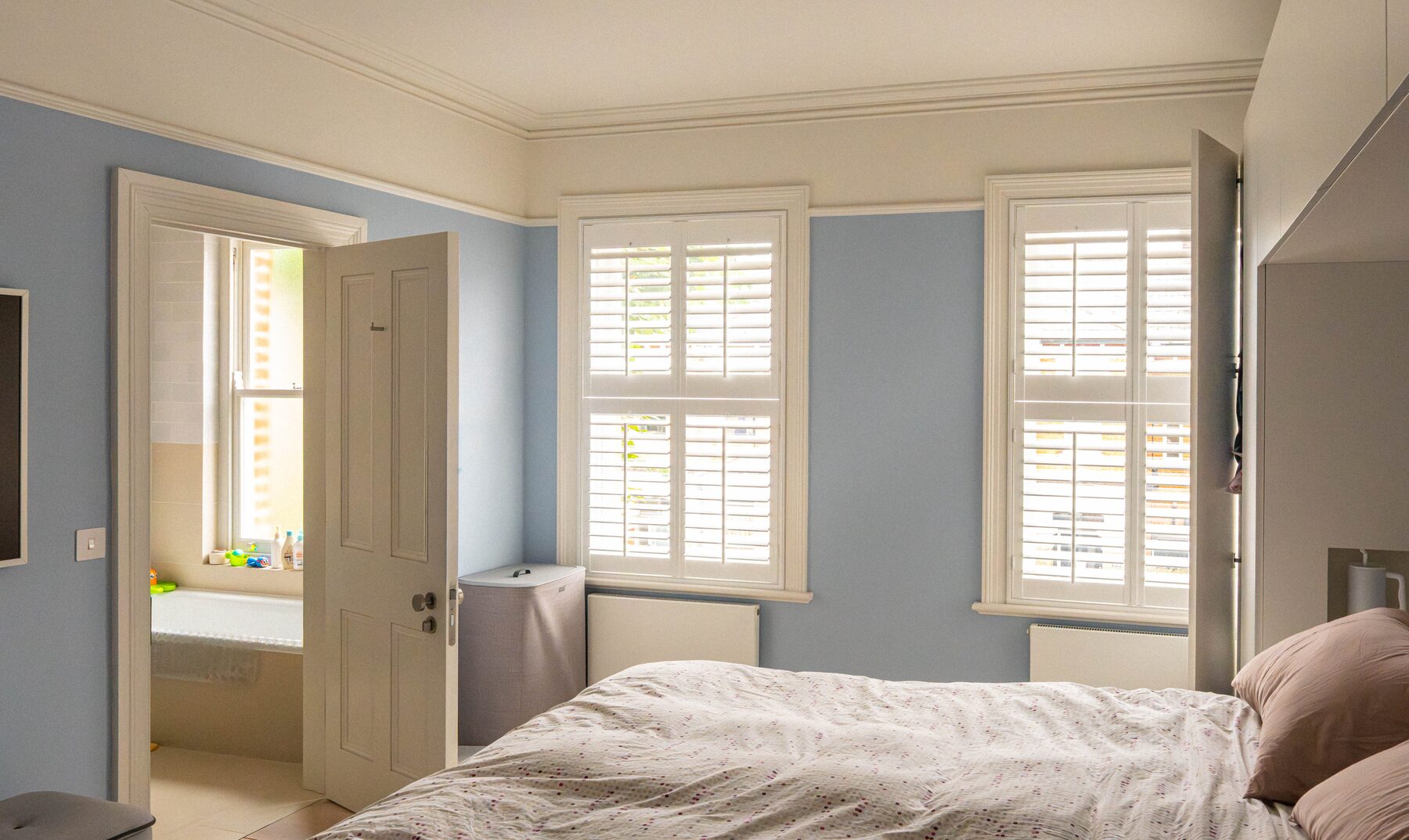 Master bedroom with plantation shutters and period cornicing